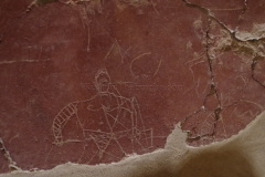 Graffiti of gladiators on a painted wall. Displayed in a special exhibition at the MuséAl.