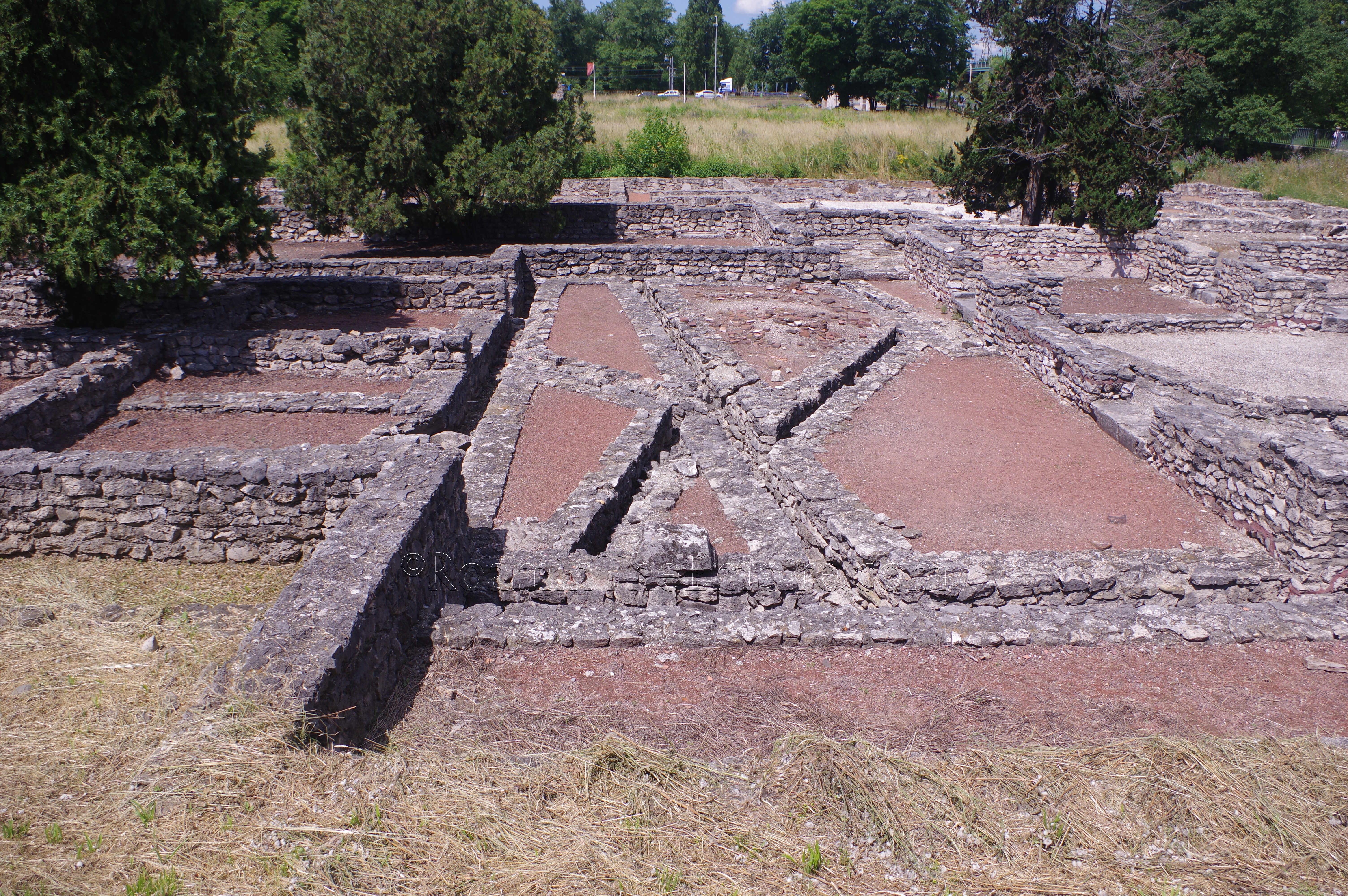 Apodyterium of the northeastern bathing complex. Frigidarium and latrines visible to the right.