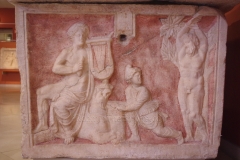 One end of a marble sarcophagus depicting the myth of Apollo and Marsyas. From Szekszárd. Dated to the late 2nd or early 3rd century CE. Magyar Nemzeti Múzeum.