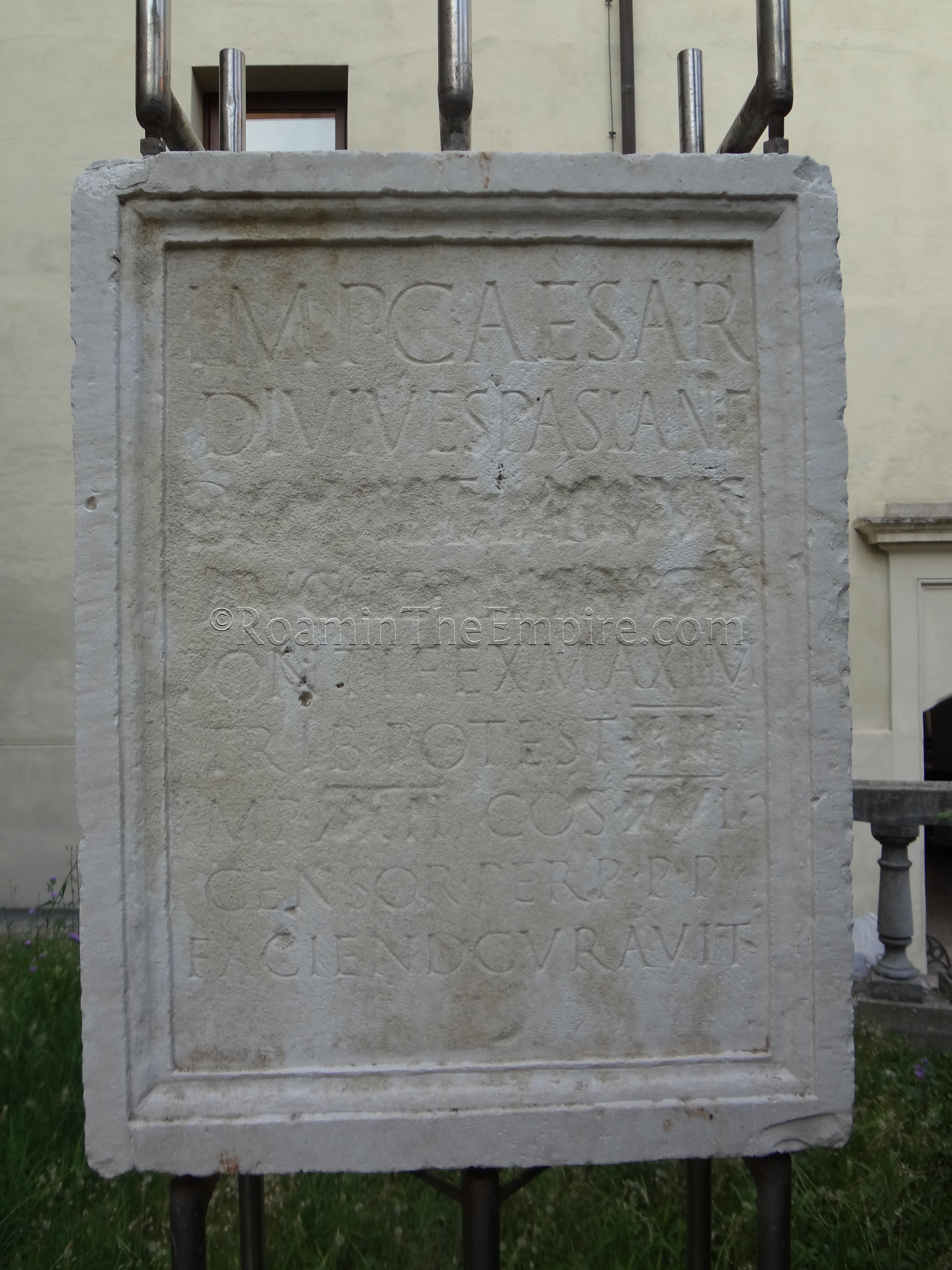 Inscription noting the construction of works by Domitian, whose name is removed in damnatio memoriae, in 93 CE. Found on the Via Flaminia outside Rimini, now in the lapidary garden of the Museo della Città.