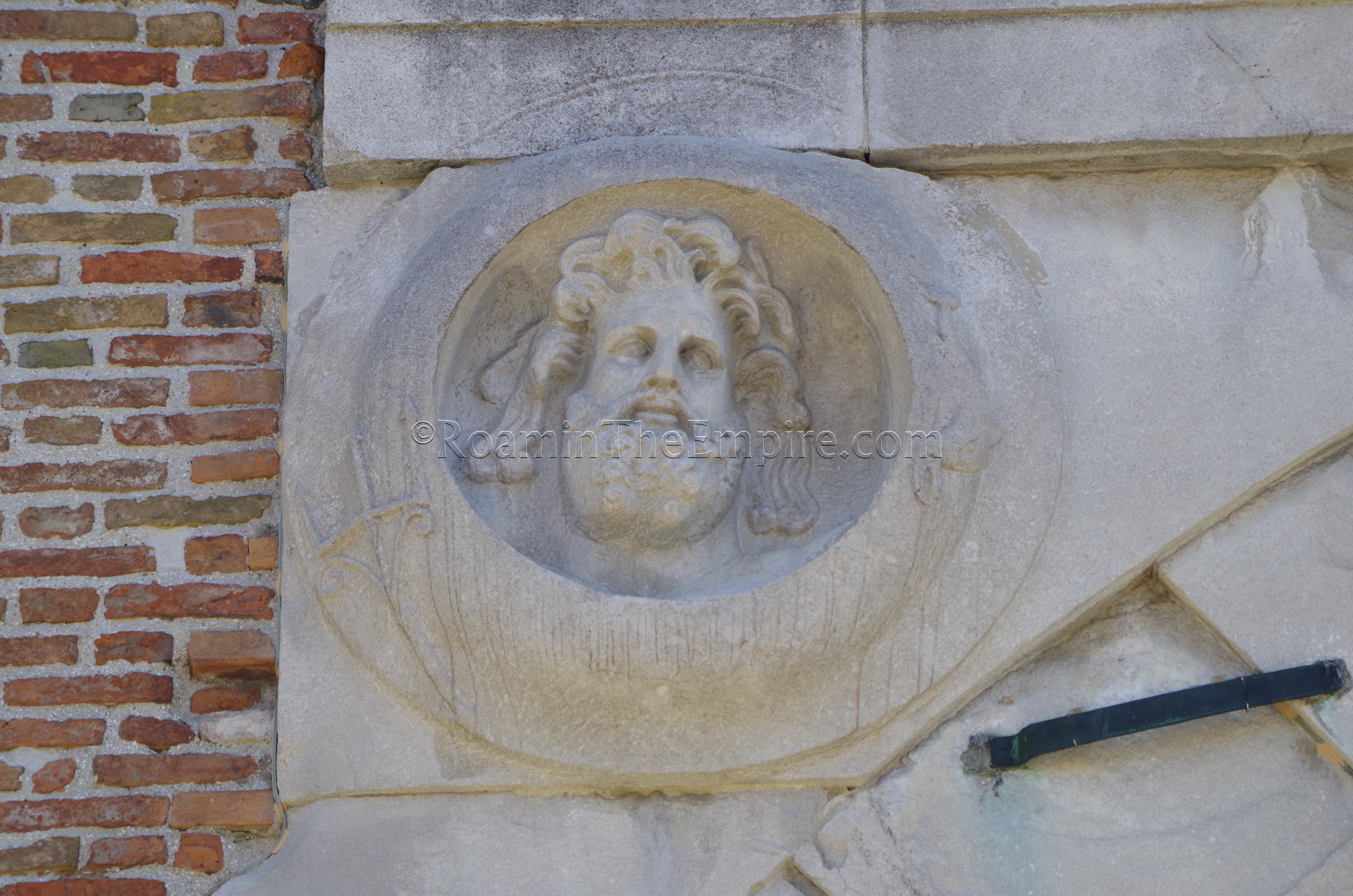 Clipei with image of Neptune on the interior facade of the Arco di Augusto.