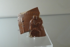 Fragment of Arretine ware vessel with the image of a woman playing a harp. From the workshop of Rasinius.