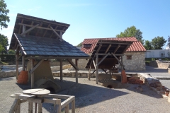 Reconstructed kilns in front of the House of the Cloth Merchant.