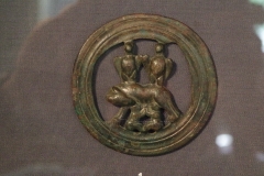 Decorative bronze piece depicting two legionary standard eagles above the she-wolk suckling Romulus and Remus. Museum Carnuntinum.