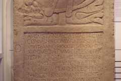 Funerary inscription dedicated by Marcus Antonius Basilides, frumentarius of Legio X Gemina, to his wife Augustania Cassia Marcia and son Marcus Antonius Philetus. Augustiania lived to the age of 33 years, 11 months, and 13 days, while her son was aged  3 years, 8 months, and 10 days when he died. Terms of endearment to the two deceased were later added to the bottom of the stele, as was the text on the ship, perhaps in longing of their homeland. Found at the legionary camp and dated to the 3rd century CE. Museum Carnuntinum.