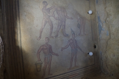 Mosaic depicting slaves, the bottom two named Titus and Cassius according to their cloth wrappings, performing the massage activities that would have taken place in the room. From the bathing complex.