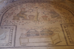 Mosaic from the apse area of an apsidal hall depicting women weaving the rose crowns to be given to the winners of scenic games depicted in the incomplete mosaic from the rest of the hall.