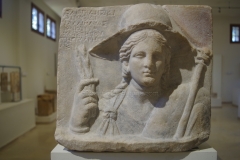 Dedicatory inscription by Kallimachos and Kleta to Isis, Serapis, and Anubis, possibly in thanks for a safe journey. Isis is depicted in the guise of Demeter. From the Sanctuary of Isis. Dated to the 2nd century BCE.  Archaeological Museum of Dion.