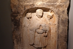 Funerary stele of the locksmith Caratullius, who is depicted in relief with locksmith tools in hand and locks hanging around him. Dated to the 3rd century CE. Musée de La Cour d'Or de Metz.