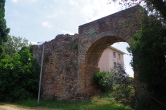 Section of wall with aqueduct channel and reconstructed arch.