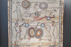 Mosaic depicting a gladiator battle between the murmilliones Symmachus (the victor) and Maternus (who died). Dated to the 3rd century CE, from Rome.