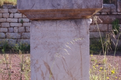 Statue base dedicated to Domitian at the west end of the north stoa of the agora.