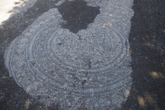 Detail of the inscribed mosaic in the northwest corner of the odeon area.