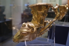 Gold rhyton in the shape of a ram's head with figures of Dionysus and the maenad Eriope on the side. Part of the Panagyurishte Treasure. Regional Archaeological Museum.