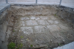 Excavation exposing the earlier 2nd-3rd century CE layer in the magistrate's house.