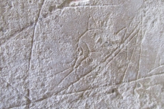 Graffiti of a fantastical creature on the doorway of the Mausoleum of the Engineers at the paleochristian necropolis.