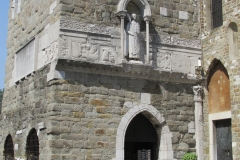 Remains of the propylaeum visible on the exterior facade of the bell tower of Cattedrale di San Giusto Martire.