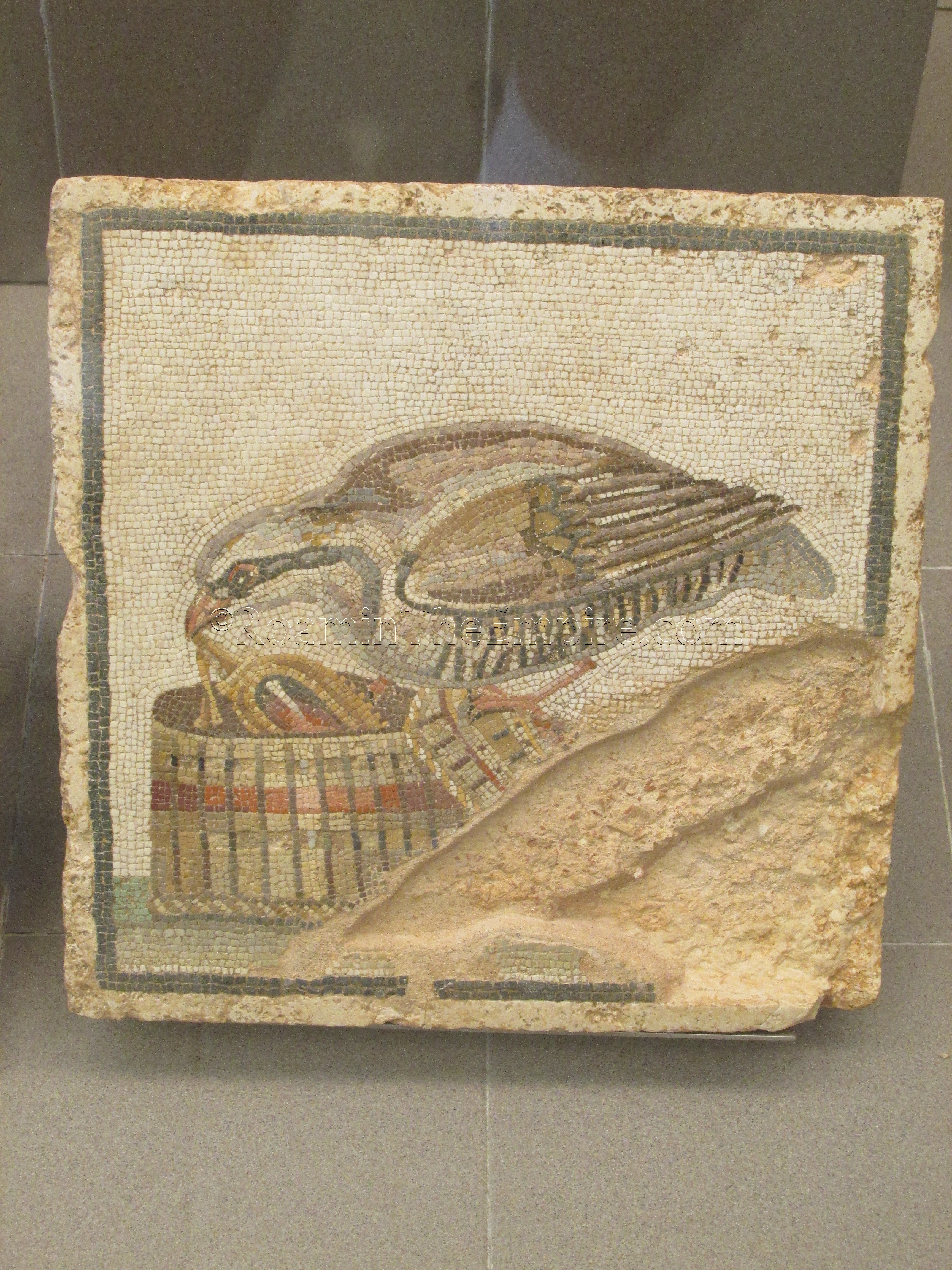 Mosaic panel of a partridge stealing jewelry from a box.