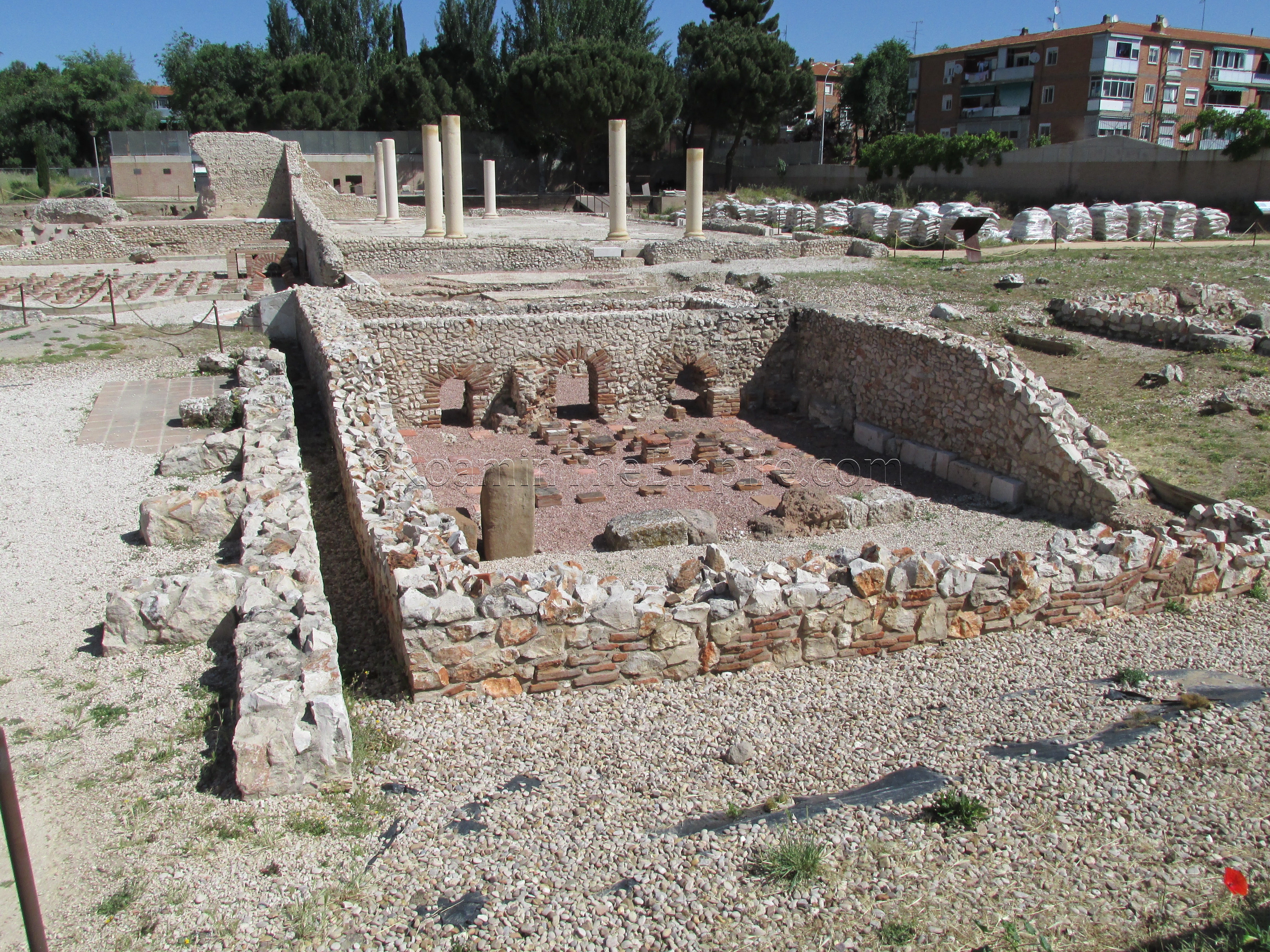 Forum Baths with basilica in the background. Complutum.