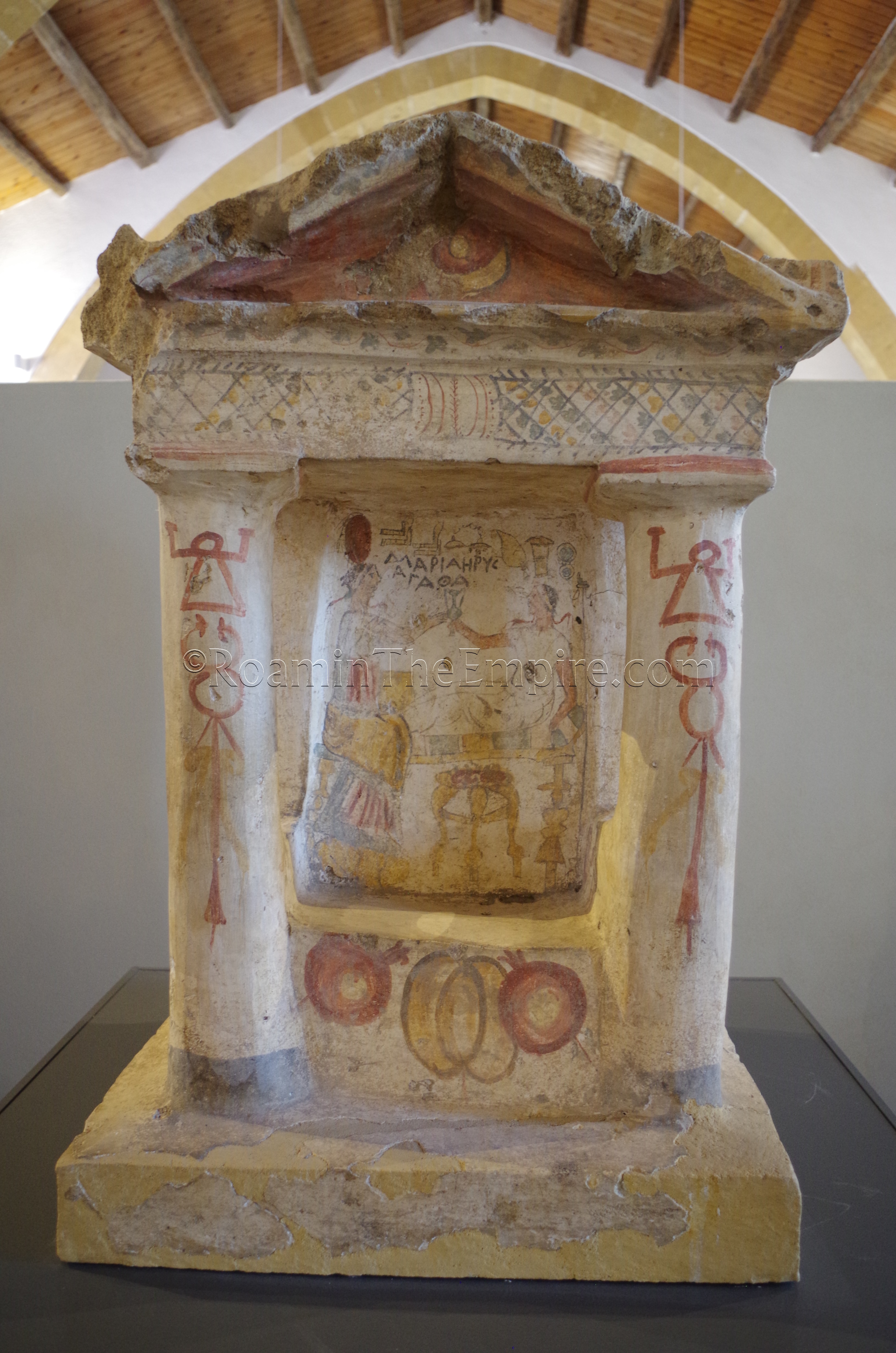 Painted funerary aedicula from the 2nd century BCE with Greek funerary banquet motiff and Punic symbols such as the Tanit sign and Caduceus on the columns.