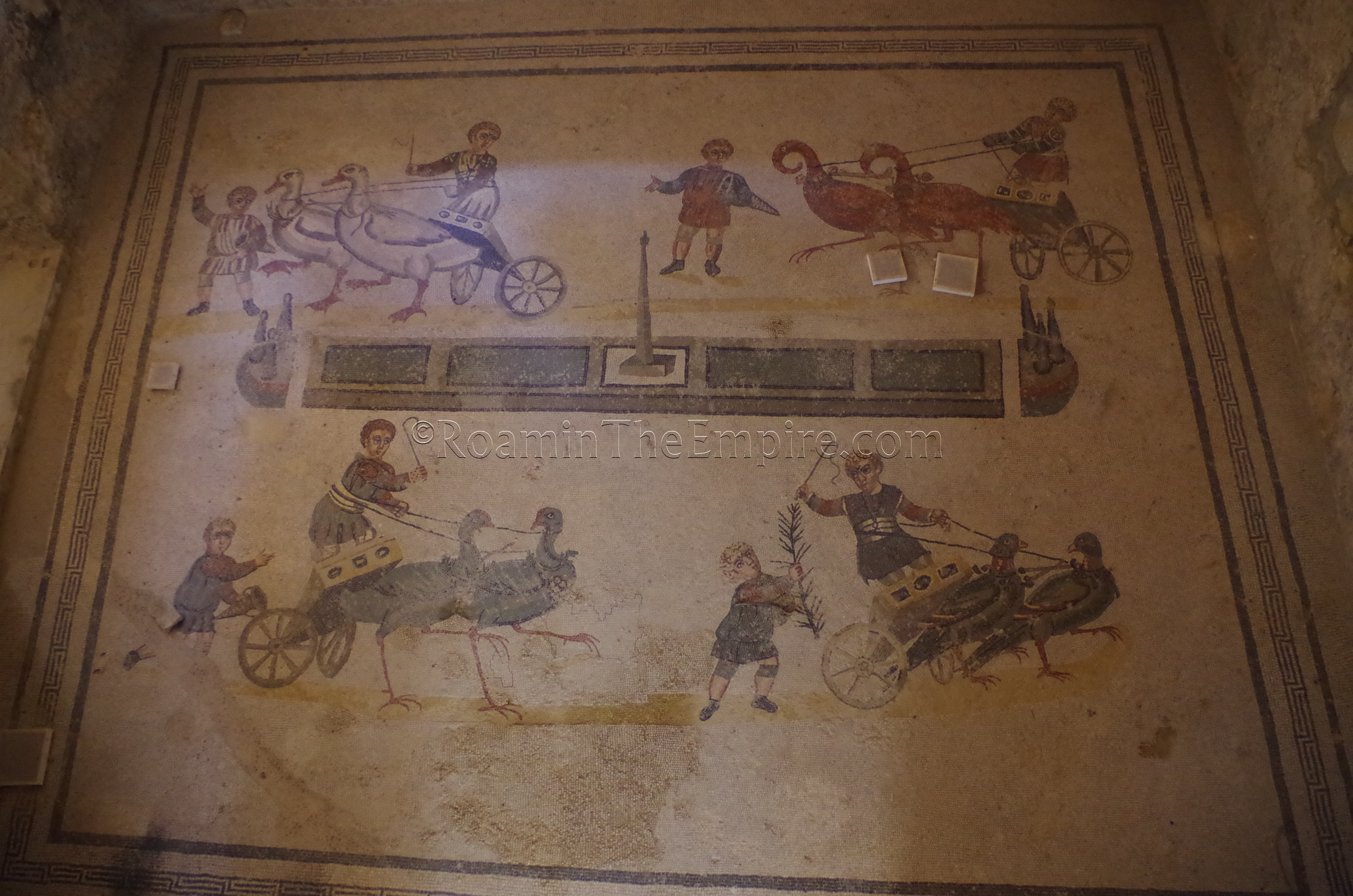 Mosaic depicting a children and birds in a chariot race, from the antechamber of an apsidal hall. Villa Romana del Casale.