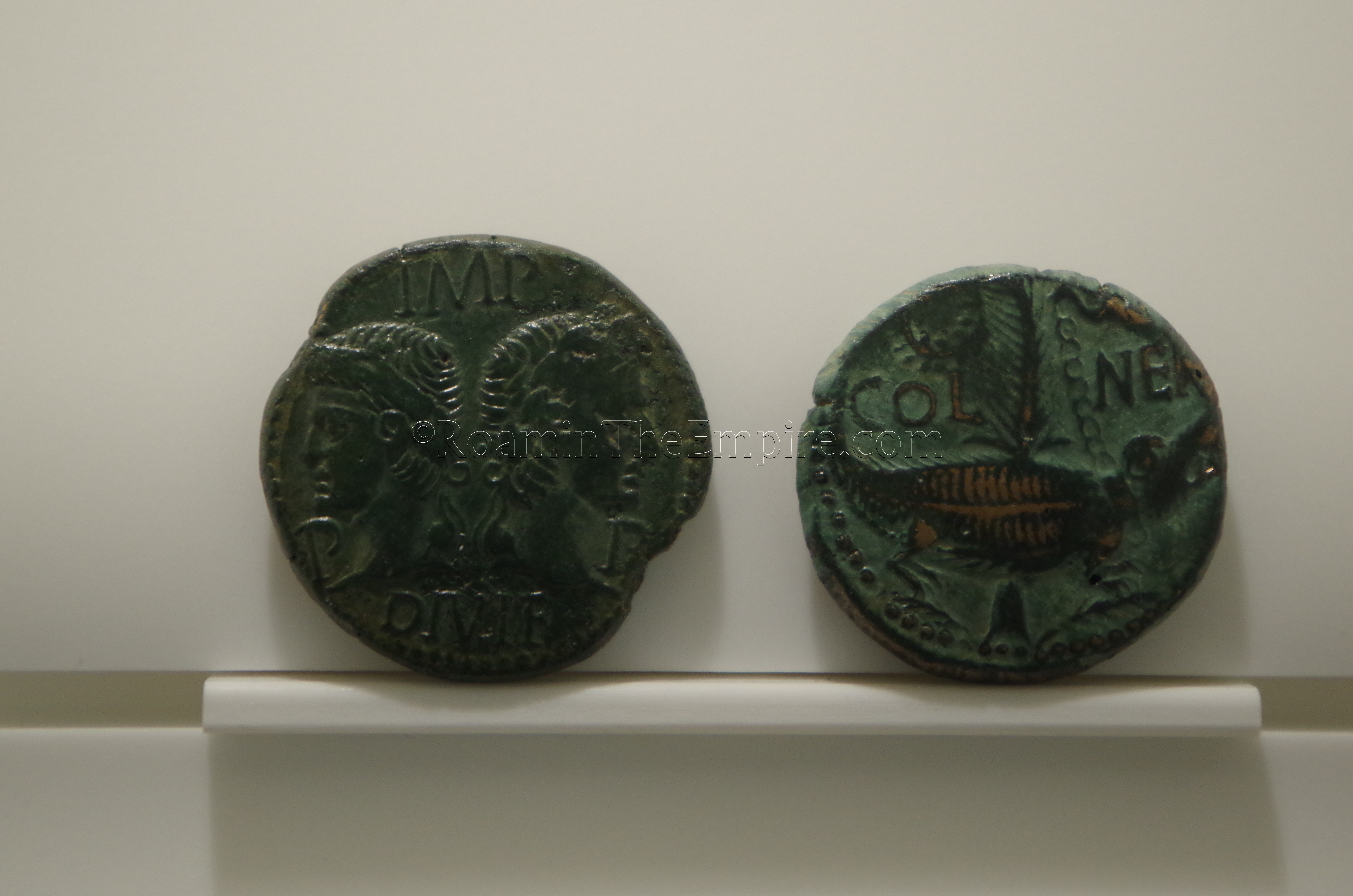 Coin featuring Augustus and Agrippa on the obverse and the crocodile chained to a palm tree, a symbol of Nemausus, on the reverse. Dated to 14/15 CE and displayed in the Musée de la Romanité.