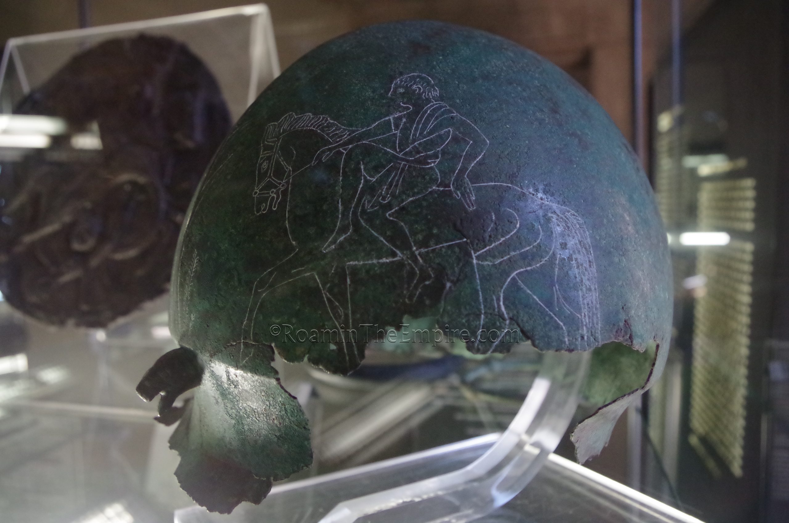 Bronze Negau helmet inscribed with an image of horsemen. From a 6th century BCE Picene necropolis at Rapagnano. Museo Archeologico Nazionale delle Marche.