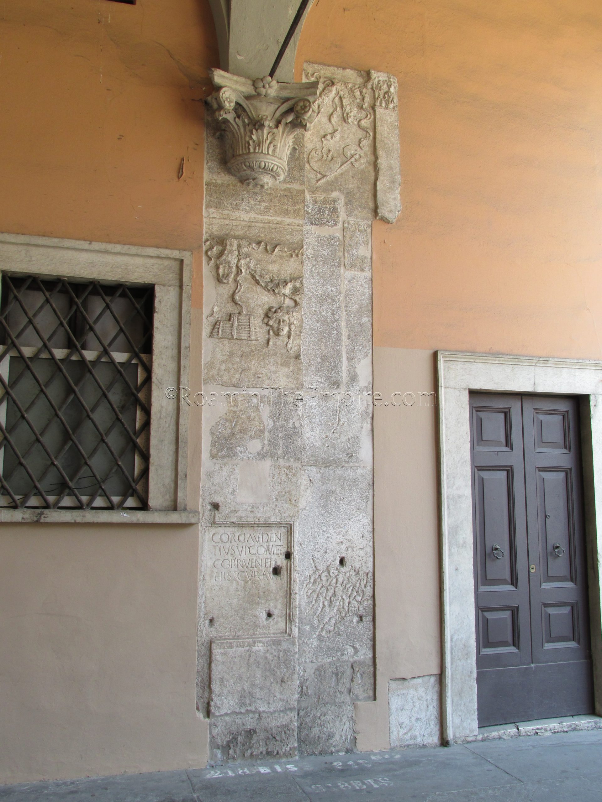 Spoliated material in a corridor off the Piazza della Loggia.