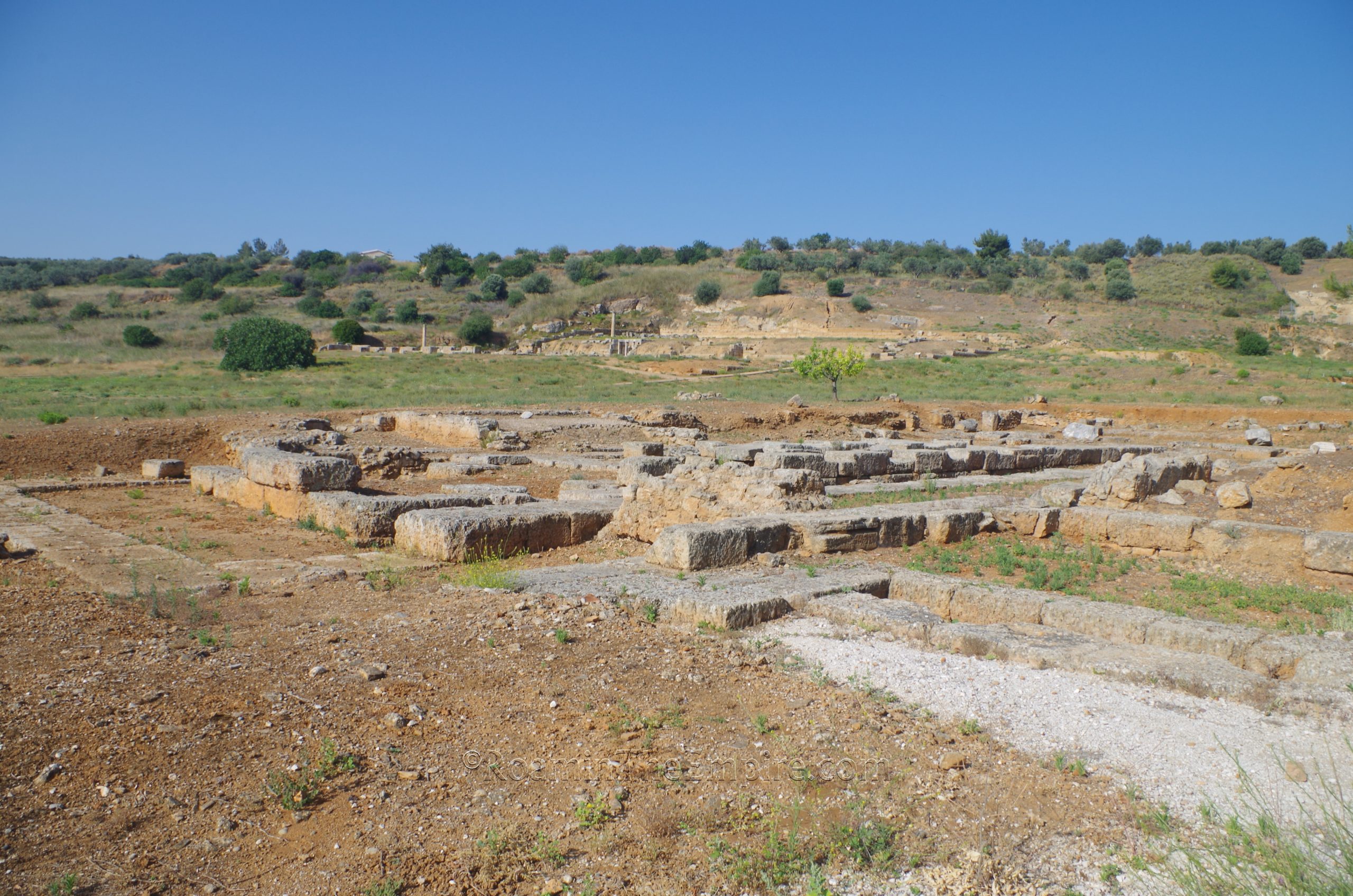 Archaic Temple with palaestra/gymnasium in the background. Sicyon.