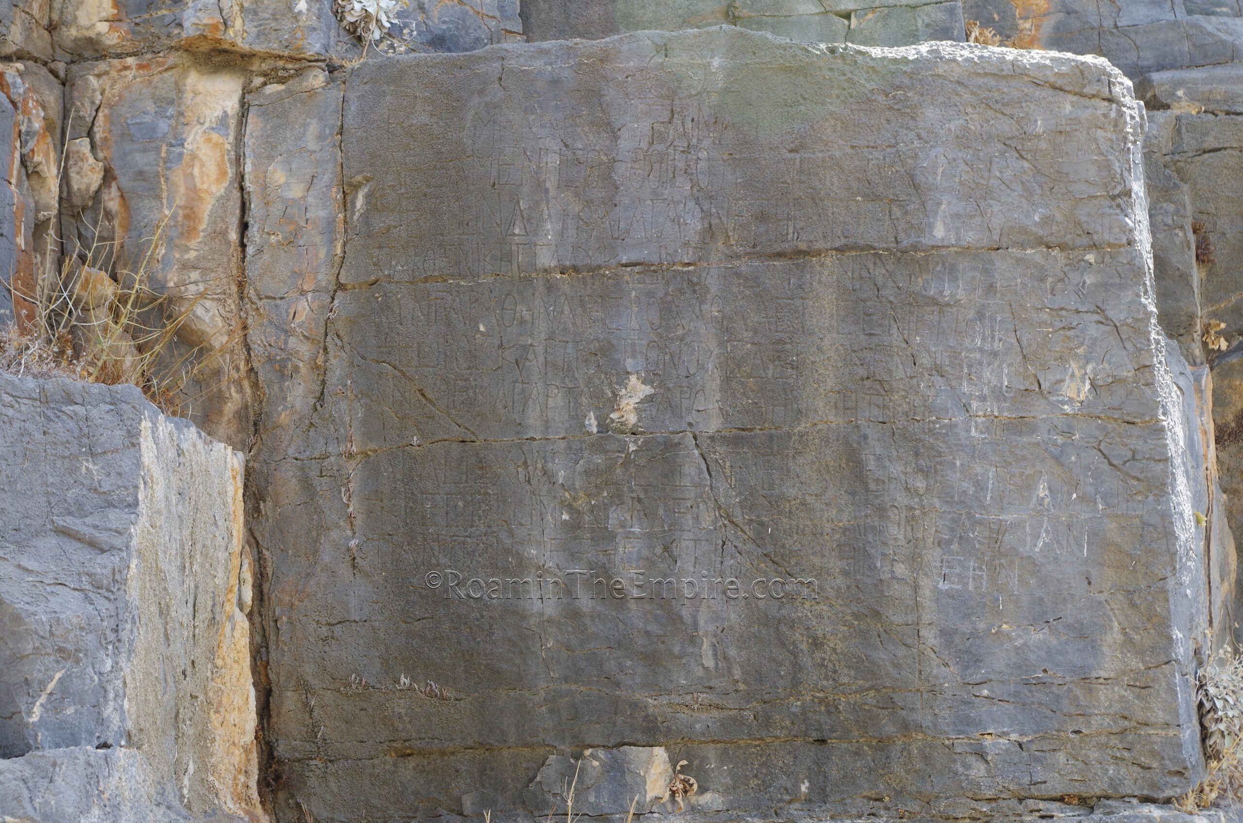 Rock-cut inscription below the entry of the acropolis.