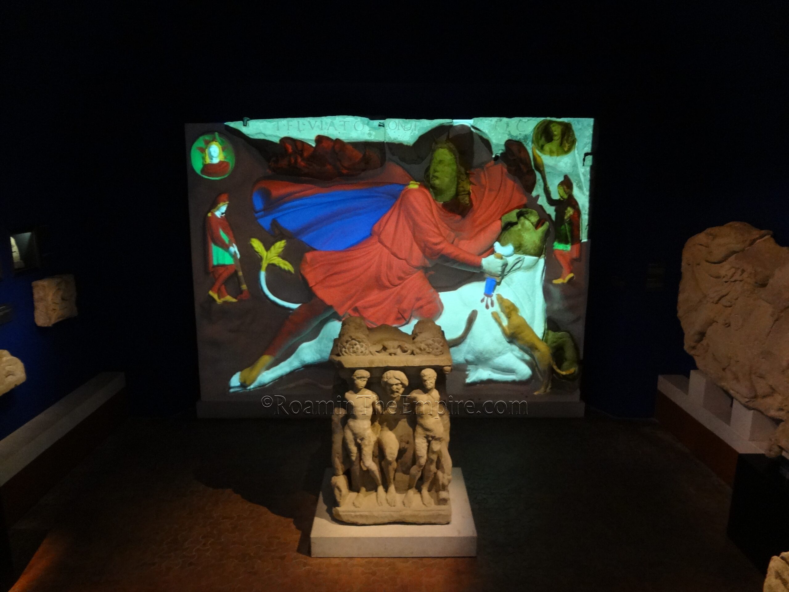 Large tauroctony relief from Mithraeum III with a reconstructed color projection with an altar dedicated by Magnius Heraclea in front of it, also from Mithraeum III. Both dated to the late 2nd or early 3rd century CE. Museum Carnuntinum.