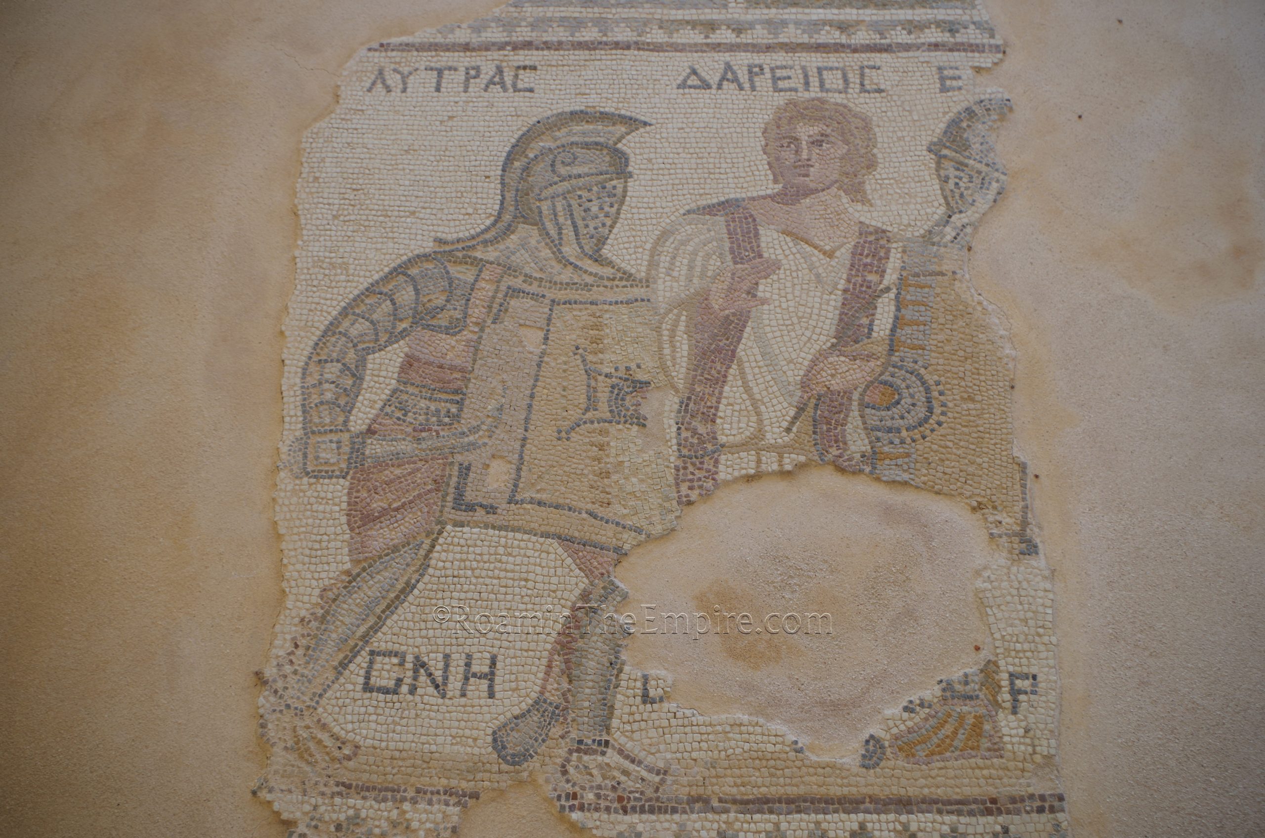 Detail of a mosaic from the House of the Gladiators depicting the gladiator Lytras being separated from his opponent by the rudis Darios. Curium.