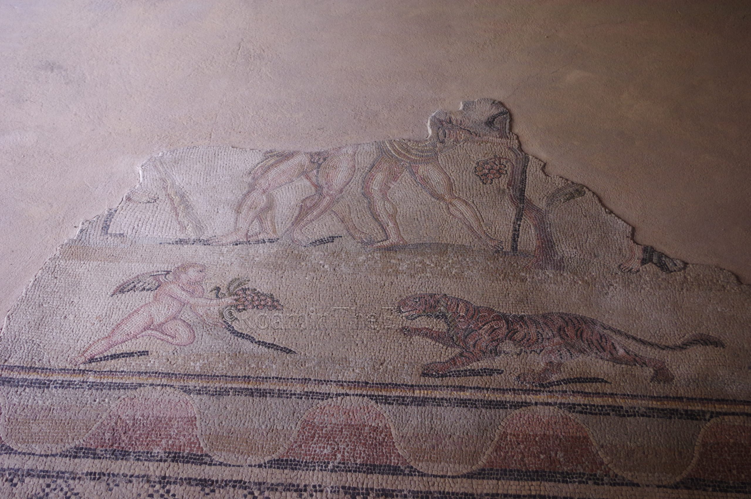 Remaining mosaic depicting drunken Hercules in the apsidal room of the Hercules Villa.