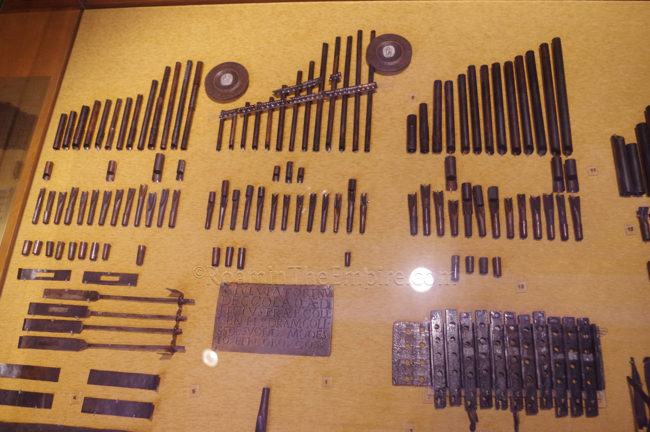 Elements of the hydraulis, including the dedication plate noting the date of 228 CE. Aquincum Archaeological Museum.