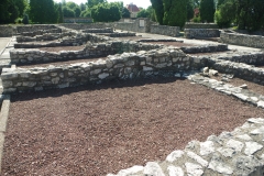 Shops along the south side of the macellum and corresponding tabernae along  Street E.
