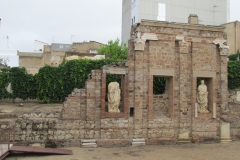Niches with copies of statues in the wall of the portico in the imperial forum.