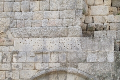 Mountings for a bronze inscription on the north side of the east entrance of the theater.