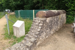 Enclosure wall of the funerary monument with possible covered bridge stones in the background.