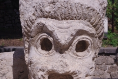 Theater mask relief displayed on the grounds of the theater.