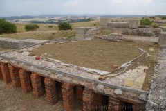Caldarium with marble floor supported by a hypocaust system from the Los Arcos I baths at Clunia.