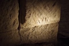 Mason mark for Legio VI Victrix on the reverse of blocks around the stairs leading from the port to the forum.