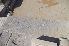 Inscription noting the rebuilding by the venerable high priest using in the lintel of a doorway of the bathing complex.