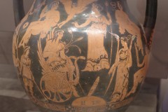 Red figure amphora with an Elusinian motif; Triptolemos rides a winged chariot with snakes while Persephone and Demeter hold torches. around a stone omphalos. Dated to 425-375 BCE. Archaeological Museum of Kos.