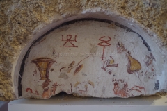 Painted lararium aedicula with a funerary banquet scene and Punic Tanit and caduceus. Dated to the 2nd-1st century BCE.