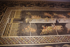 Detail of the circus mosaic with a depiction of a crashed chariot.