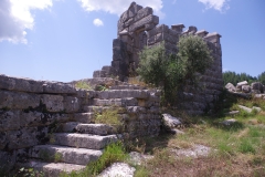 Rounded tower and stairway to the south of the road.