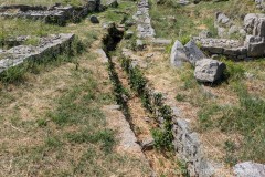 Drainage canal beneath the street running parallel to the wall through the residential neighborhood north of the Porta Caesarea.