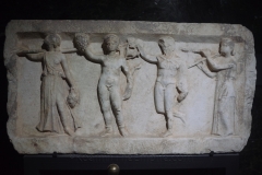 Relief of Dionysus with the Muses Thalia and Euterpe. From Ohrid. Dated to the late 1st century BCE. Archaeological Museum of the Republic of North Macedonia.