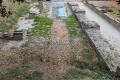 Road on the north side of the buildings along the west wall.