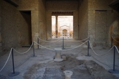 Tablinum of the Casa del Fontana Piccola at Pompeii with the atrium in the foreground and a peristyle garden beyond the tablinum.